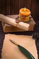 Old paper candle and quill pen photo