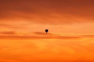 Hot air balloon flying at sunset sky photo