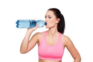 Woman drinking water from bottle isolated
