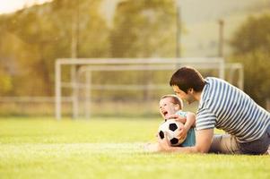 Father and son playing football photo