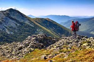 excursionista con mochila de pie en las montañas y disfrutando de la v foto
