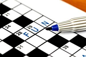 Fun in solving crossword puzzle, close up