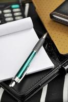 pen put on blank notepad