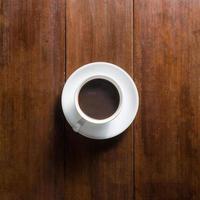Coffee cup on wooden background, top view photo