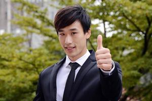 Businessman showing OK sign with his thumb up. photo