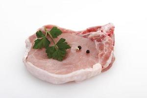 Raw pork chop peppercorn and parsley photo