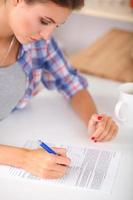 Young woman writing something in her note pad photo