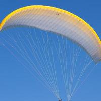 Paraglider in a blue sky photo