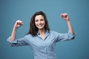 Cheerful woman with raised fists photo