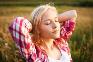 Happy blonde woman with closed eyes photo
