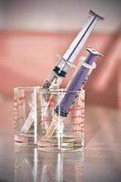 Syringe and a glass measuring cup