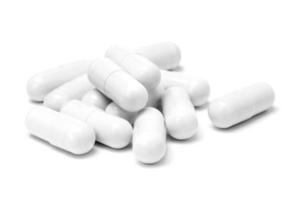 White medicine capsules isolated on white background photo