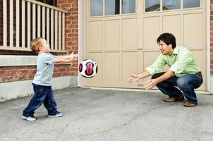 Father and son playing soccer photo