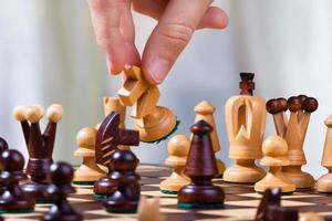 the hand of chess player with knight photo
