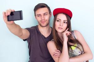 Couple friends taking selfie together wearing summer clothes  jeans shorts