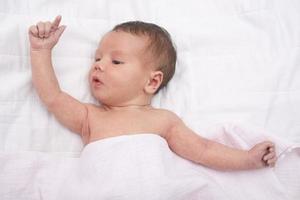 Newborn raising his arms photo
