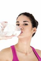 Young woman drinking water photo
