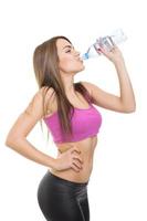 Fitness woman drinking water photo