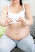 pregnant woman a cigarette break and stop smoking photo