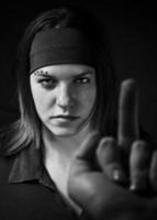 Girl ignoring a middle finger gesture and aggresively staring back photo
