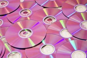 Several DVD discs in pink tint photo