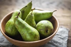 Fresh pears in the rustic bowl photo