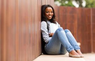 african college girl sitting on the floor photo
