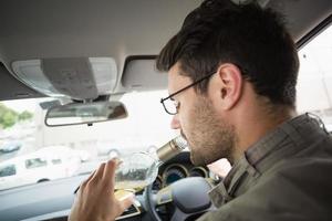 Man drinking wine while driving photo