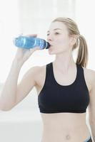 Woman drinking water during workout