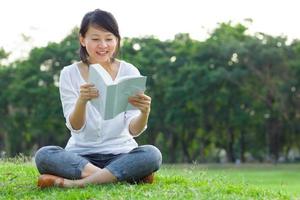 Woman reading book in park
