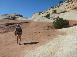 Woman hiking on desert slickrock photo