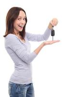 Smiling woman showing car key photo