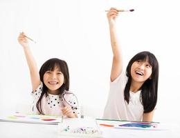 happy children painting in the classroom photo