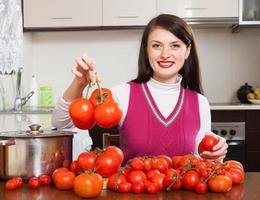 Happy woman  with red tomatoes