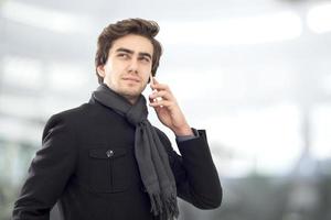 Young businessman talking on mobile phone photo