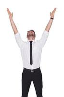 Smiling businessman cheering with his hands up photo
