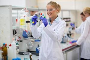 Cheerful chemist hold molecular model in lab photo
