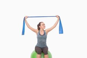 Cheerful woman training with a resistance band photo