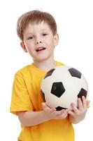 Cheerful little boy with a football in his hands