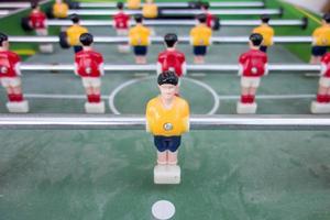 Table football game with yellow and red players photo