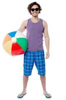 Cheerful guy ready to play beach ball