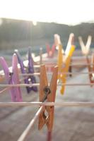 Clothes-pins hanging on a clothesline photo