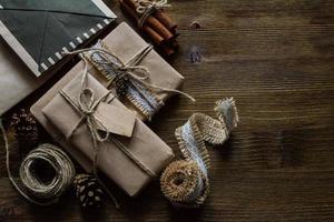 Presents in rustic wrap, wood background photo