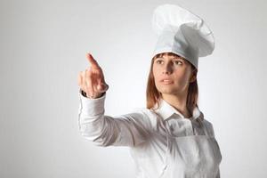 Woman chef pointing empty blank copy space isolated. photo