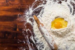 Flour, egg and rolling pin with copy space photo