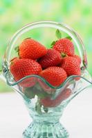 Fresh strawberries in vintage glass basket with copy space photo