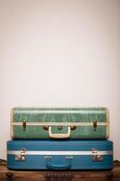 Retro Suitcases Stacked on Wood Trunk, With Copy Space photo