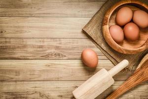 Kitchen utensils and baking ingredients on wood background, copy-space. photo