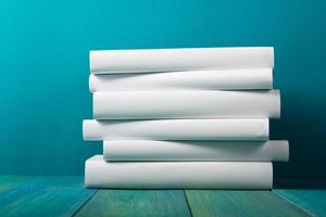 Stack of white books, grungy blue background, free copy space