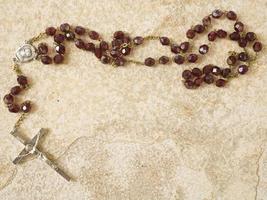 Rosary beads on stone with copy space